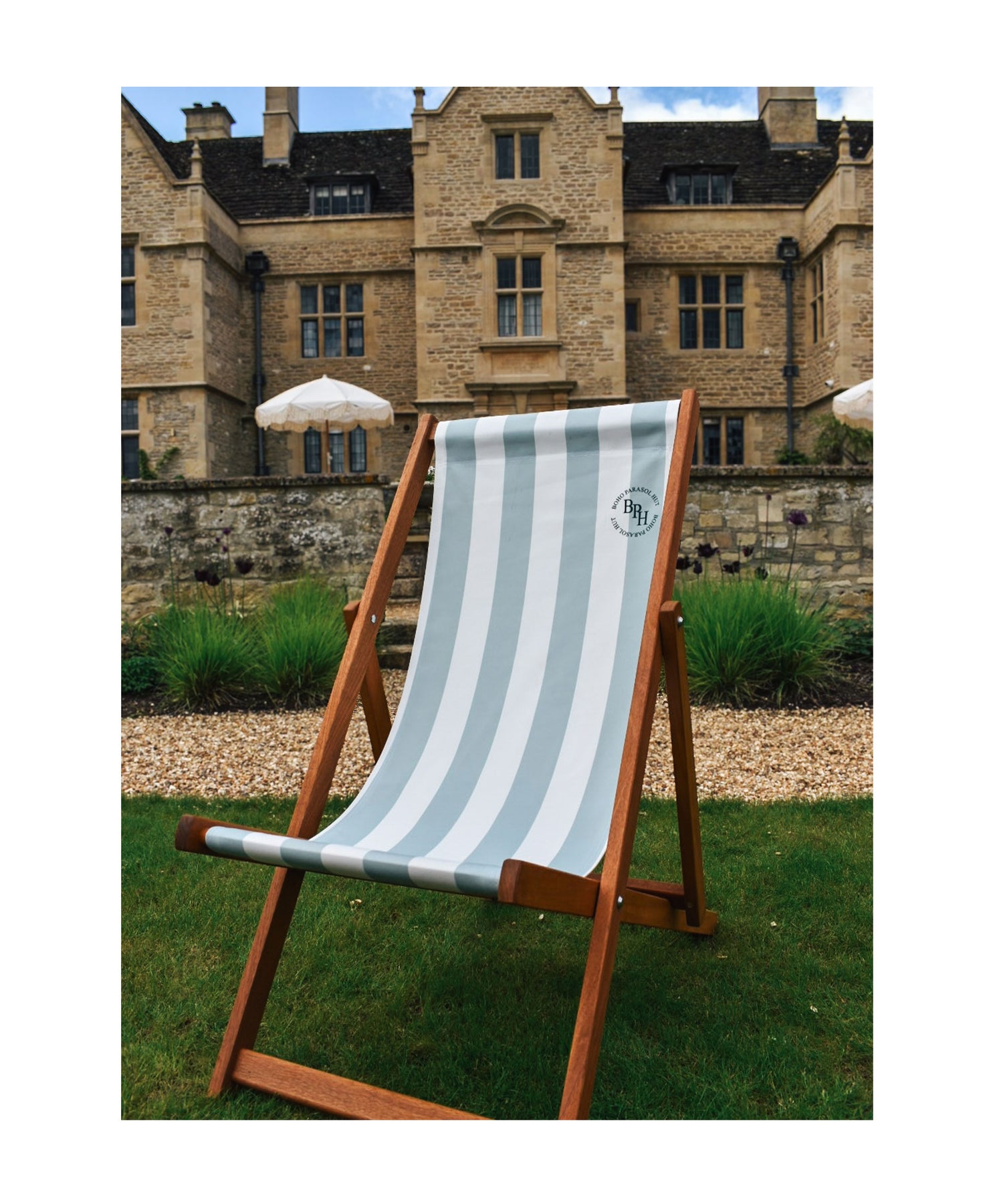 Clara deckchair with sage green stripes, beautifully matching the Clara parasol, offering a chic and comfortable outdoor seating option, made in the UK.