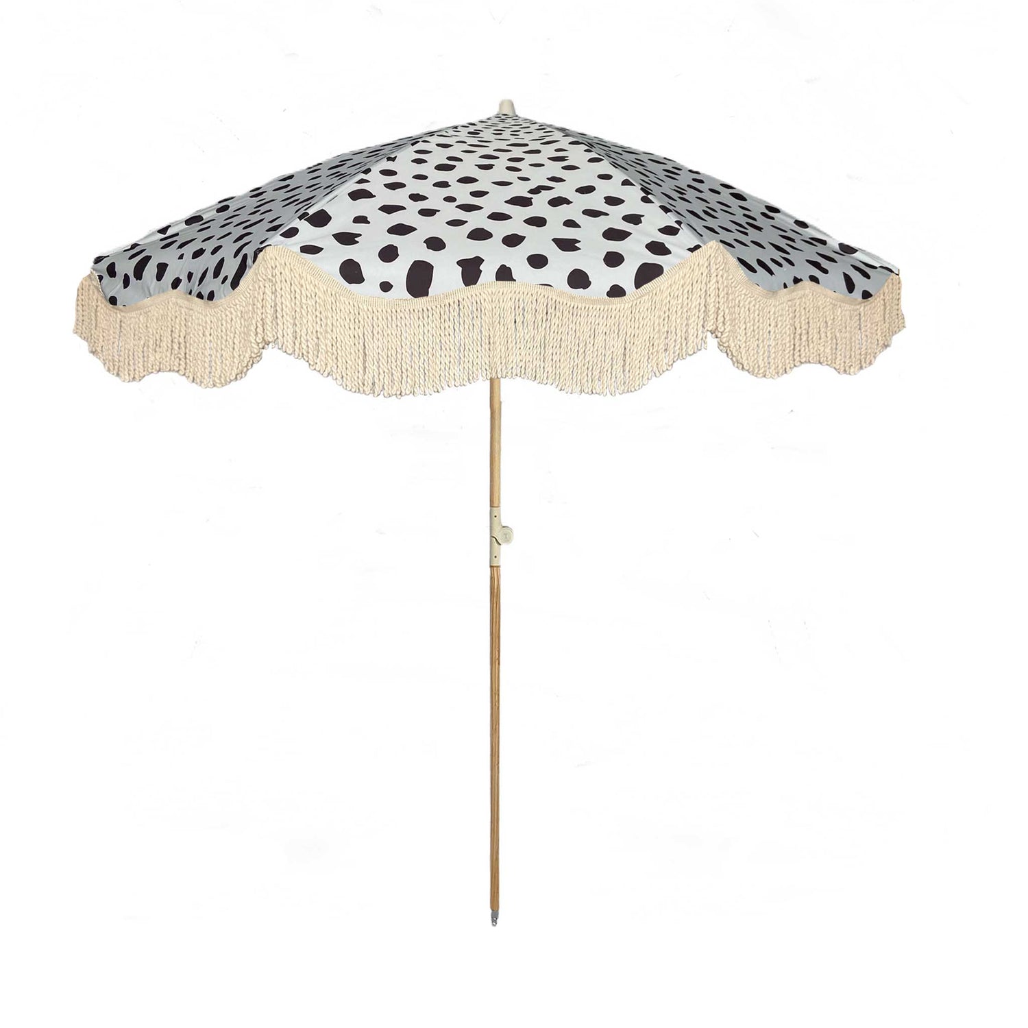 The Margot boho chic parasol featuring pastel blue with black dalmatian print, natural cotton fringing, adjustable wooden frame pole, collapsible design, and matching canvas carry bag.
