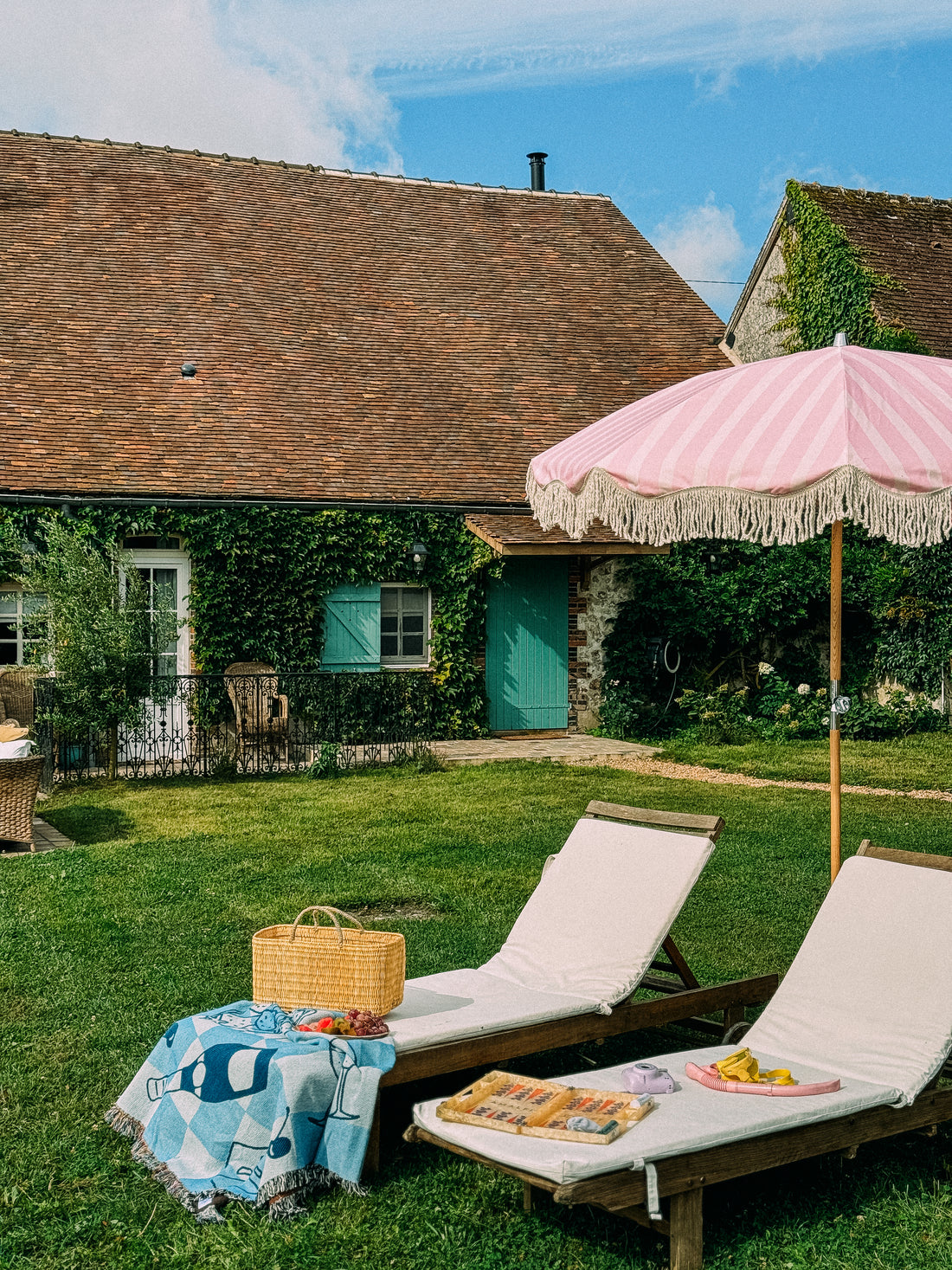 Pink on pink striped parasol with natural cotton fringing, featuring an authentic wooden frame and adjustable positioning, perfect for gardens, patios, and outdoor events