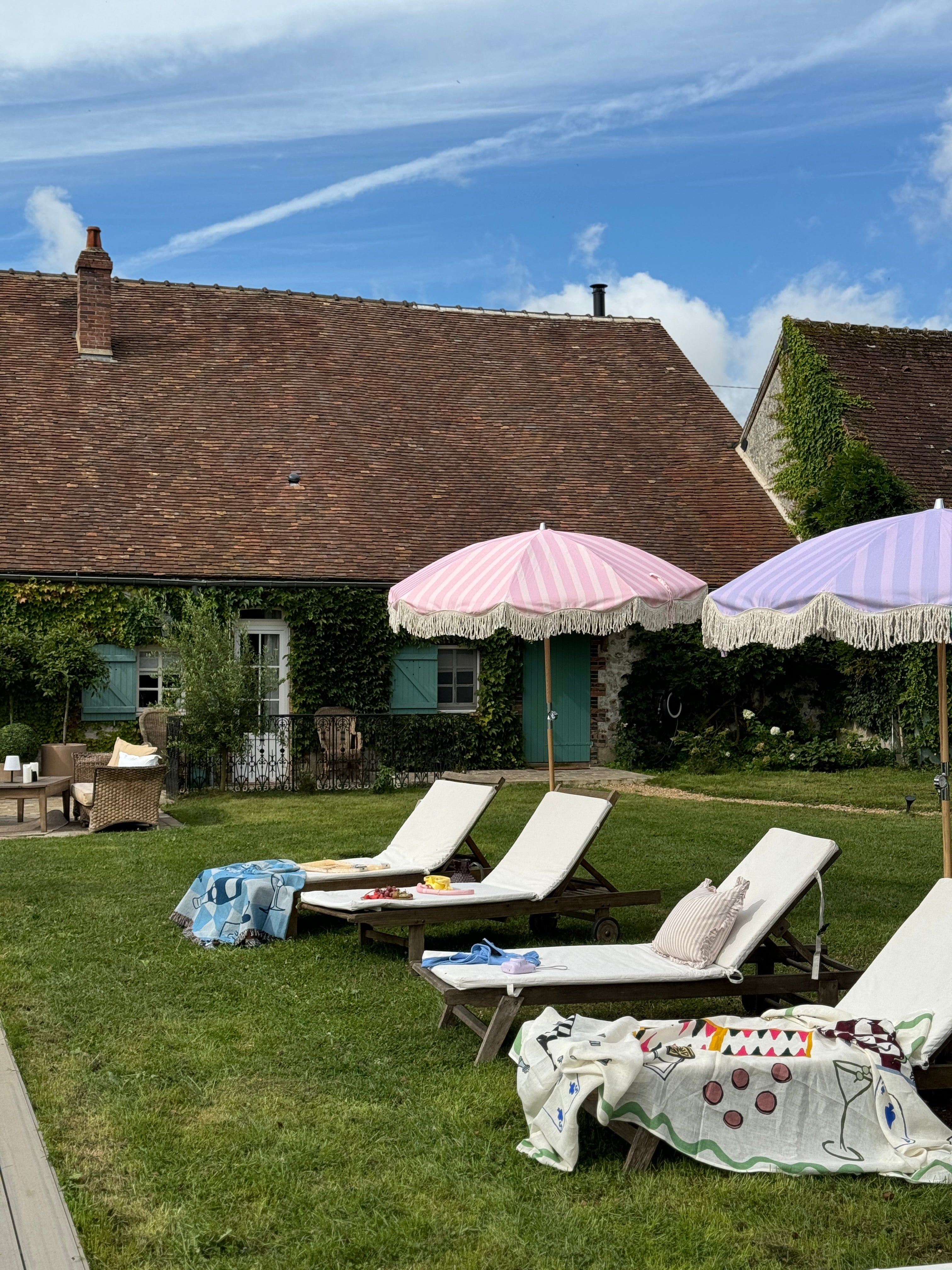 Lilac striped parasol with natural cotton fringing, featuring an authentic wooden frame and adjustable positioning, perfect for gardens, patios, and outdoor events.