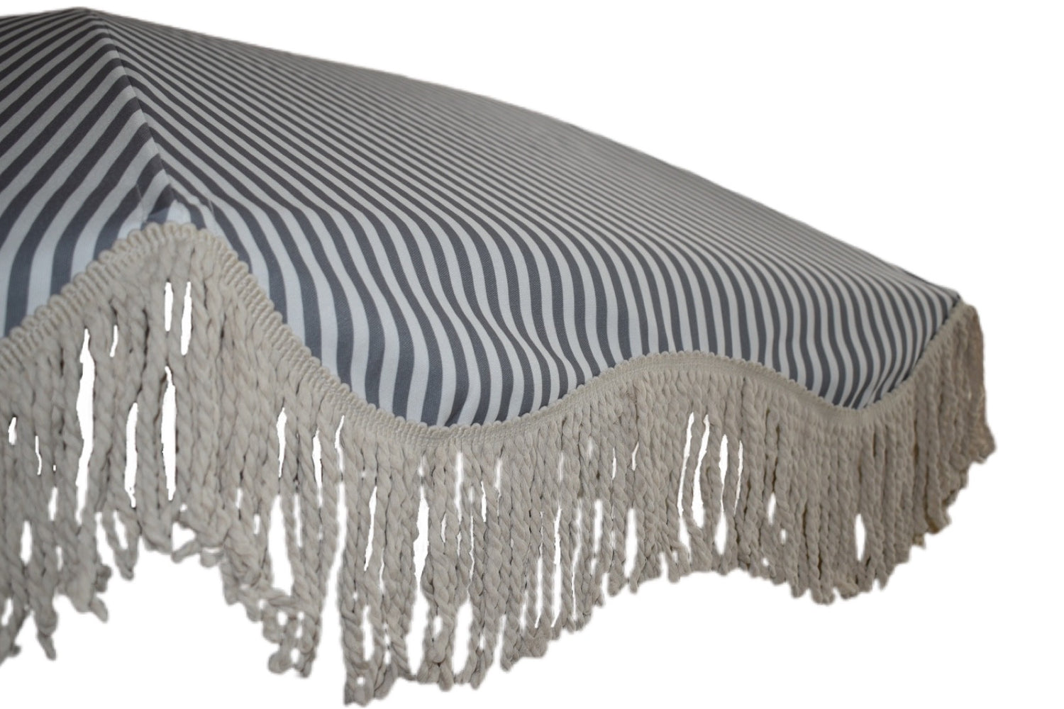 The Betty timeless chic parasol with natural cotton fringing, wooden frame pole, adjustable positioning, collapsible design, and matching canvas carry bag. Beach umbrella.