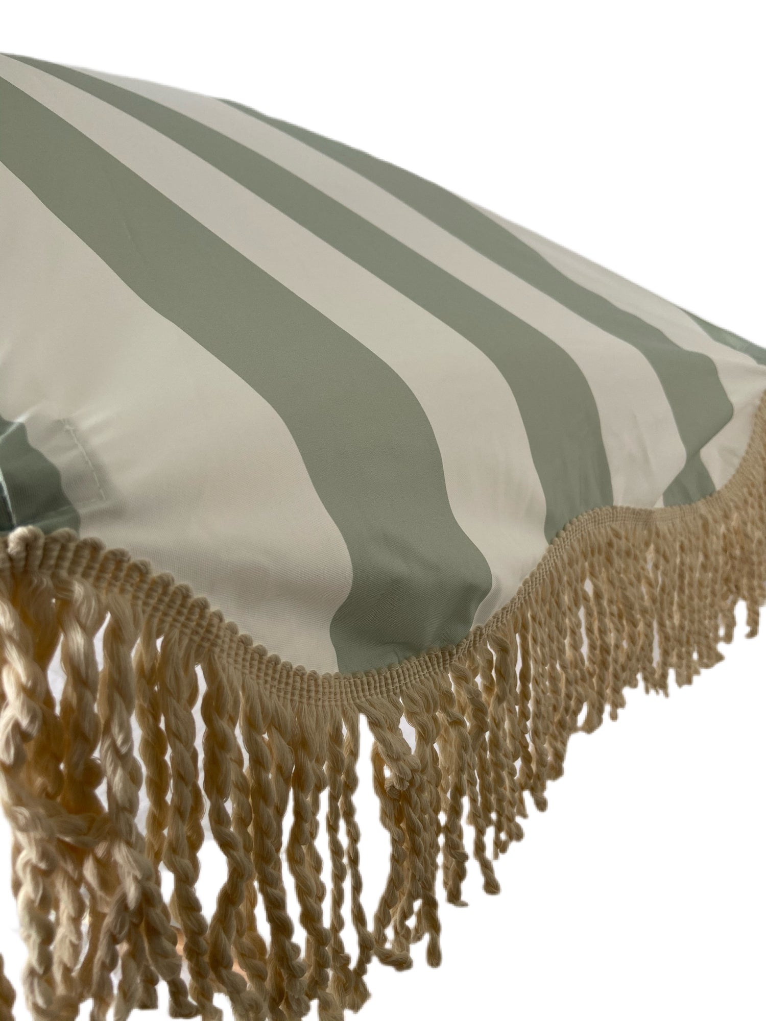 The Clara pastel green and white striped parasol with natural cotton fringing, adjustable wooden frame pole, collapsible design, and matching canvas carry bag.