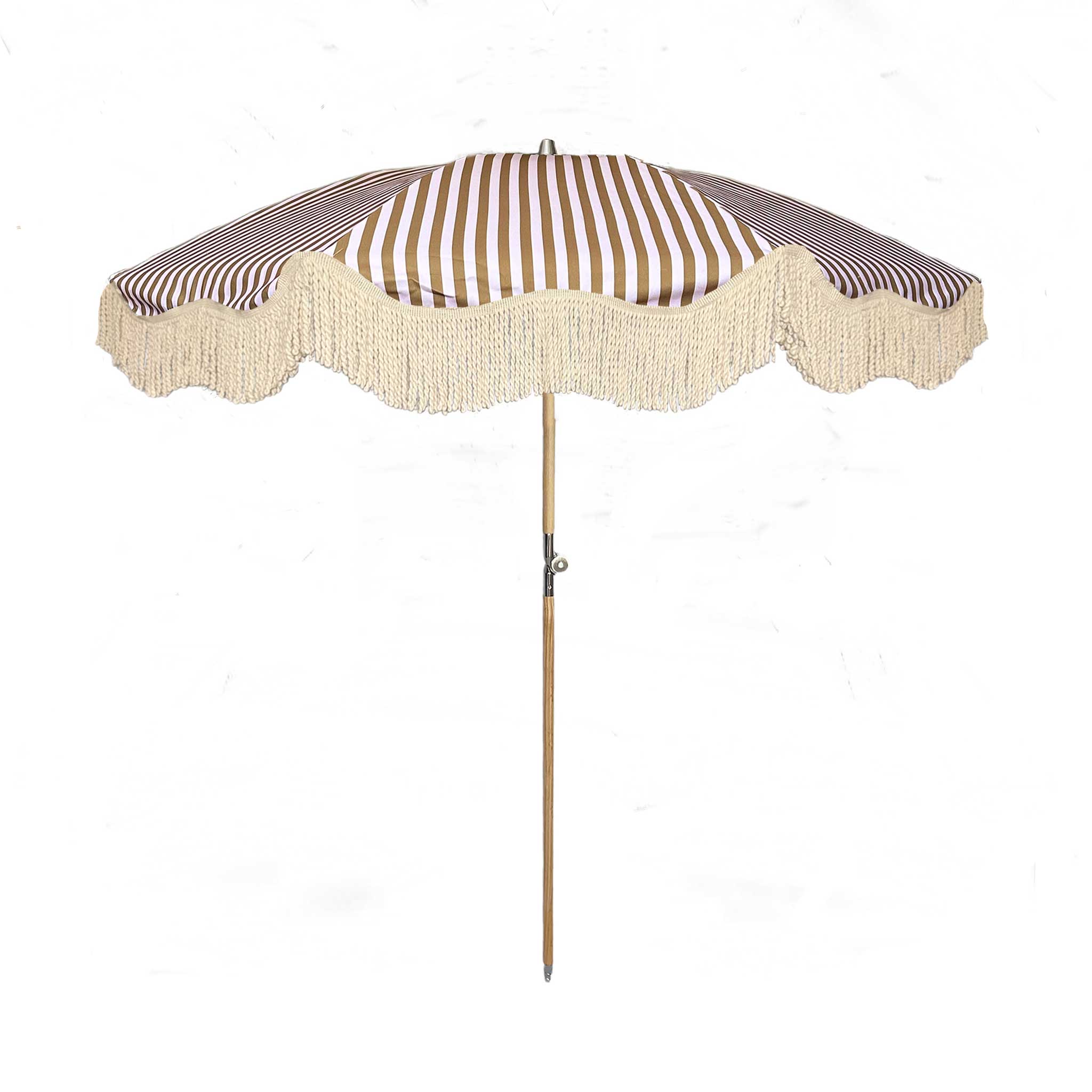 The Gigi luxury pink and camel striped parasol with natural cotton fringing, wooden frame pole, adjustable positioning, collapsible design, and matching carry bag.