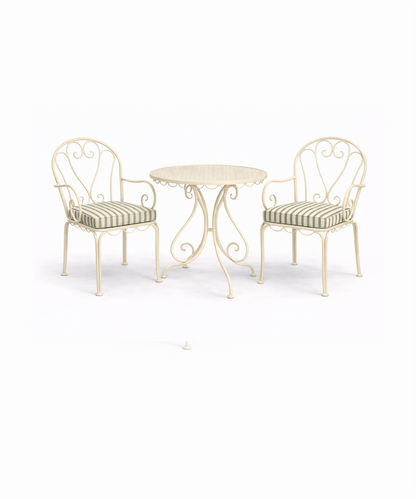 Green striped outdoor seat cushion on cream metal garden chair