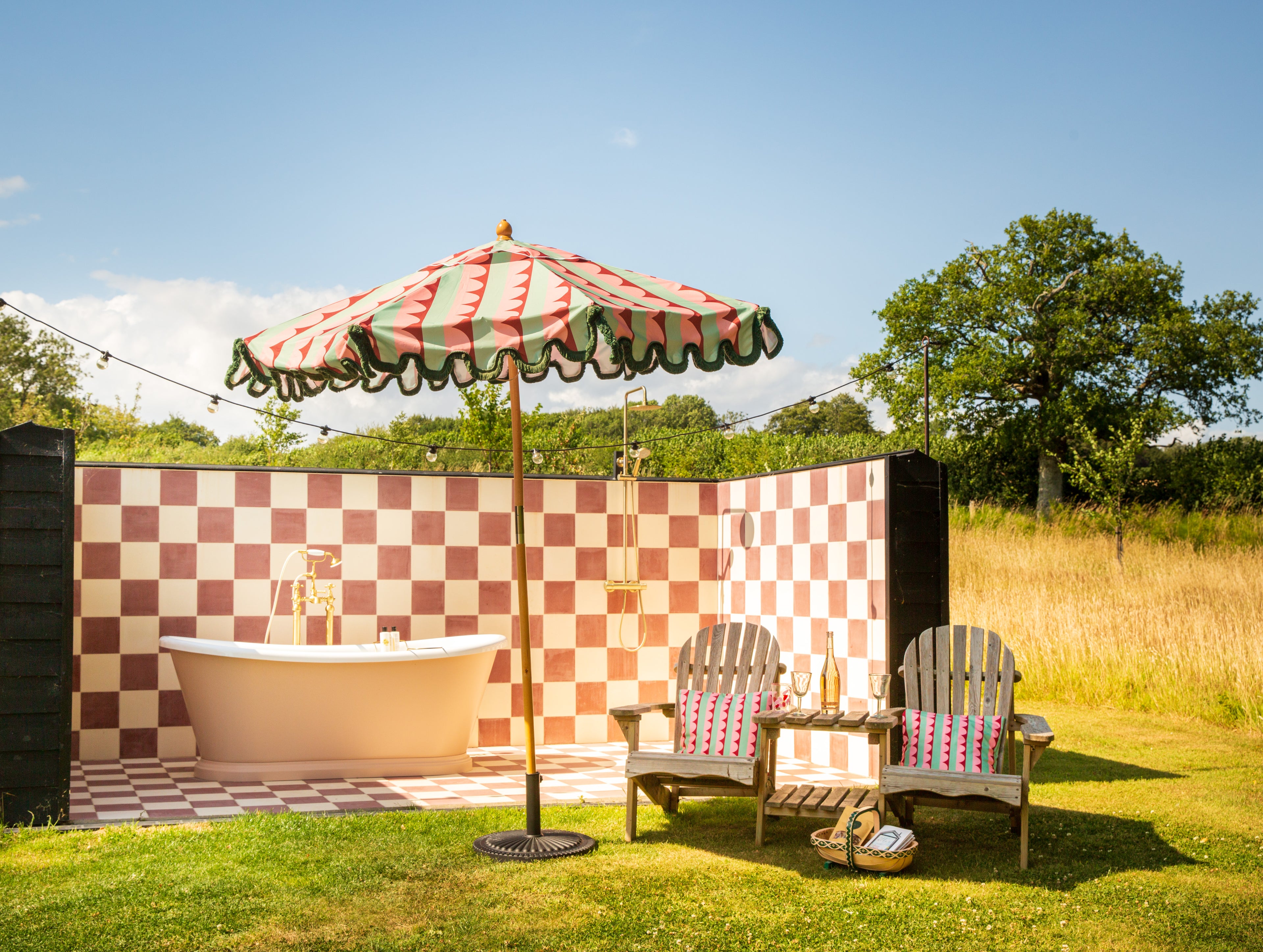 Luxury scalloped and fringed parasol styled for design-led outdoor living